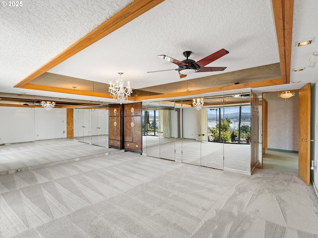 6002 E Evergreen Blvd, Vancouver, WA 98661 - unfurnished living room featuring a tray ceiling, a chandelier, carpet floors, a textured ceiling, and ceiling fan