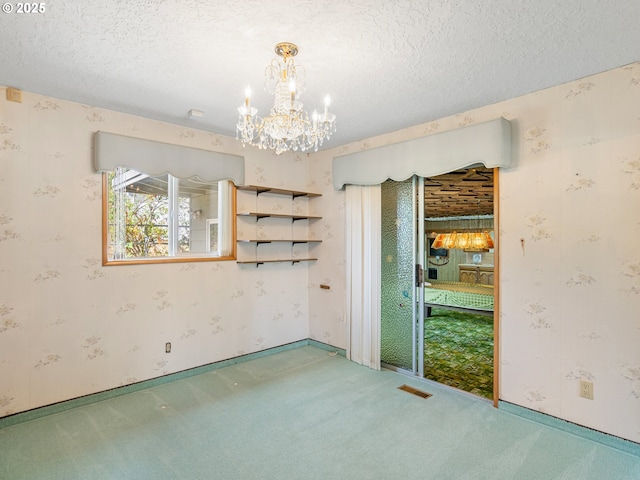 6002 E Evergreen Blvd, Vancouver, WA 98661 - spare room with a chandelier, carpet floors, wallpapered walls, and a textured ceiling