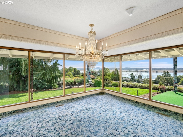 6002 E Evergreen Blvd, Vancouver, WA 98661 - unfurnished sunroom with a water view, a chandelier, carpet flooring, and a textured ceiling