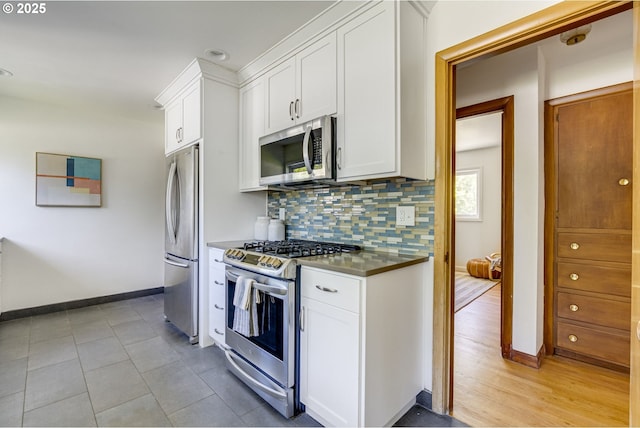 6220 SW 45th Ave, Portland, OR 97221 - kitchen with appliances with stainless steel finishes, stainless steel countertops, decorative backsplash, and white cabinets
