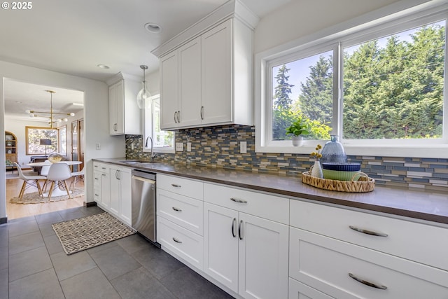 6220 SW 45th Ave, Portland, OR 97221 - kitchen with dishwasher, dark countertops, tasteful backsplash, a sink, and a chandelier