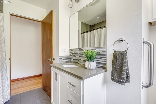 6220 SW 45th Ave, Portland, OR 97221 - full bathroom with tile patterned flooring, vanity, tasteful backsplash, and baseboards