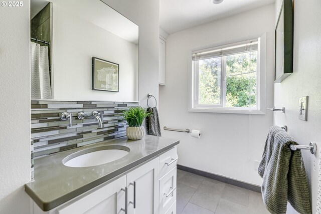 6220 SW 45th Ave, Portland, OR 97221 - full bathroom featuring decorative backsplash, vanity, tile patterned floors, baseboards, and a shower with curtain