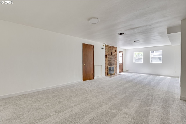 6220 SW 45th Ave, Portland, OR 97221 - unfurnished living room with carpet floors, a brick fireplace, and baseboards