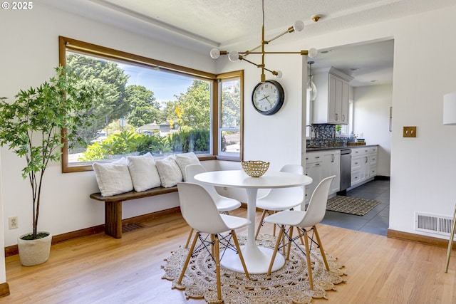 6220 SW 45th Ave, Portland, OR 97221 - dining room with light wood-type flooring and baseboards
