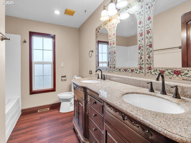 782 45th Ave, Salem, OR 97301 - bathroom with plenty of natural light, wood finished floors, baseboards, toilet, and recessed lighting