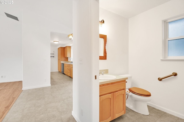 bathroom featuring tile patterned floors, visible vents, toilet, baseboards, and vanity