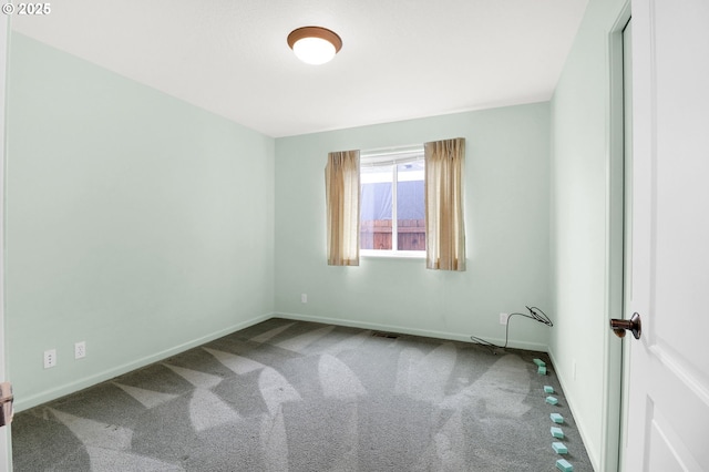 carpeted empty room featuring visible vents and baseboards