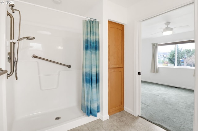 bathroom with baseboards and a stall shower