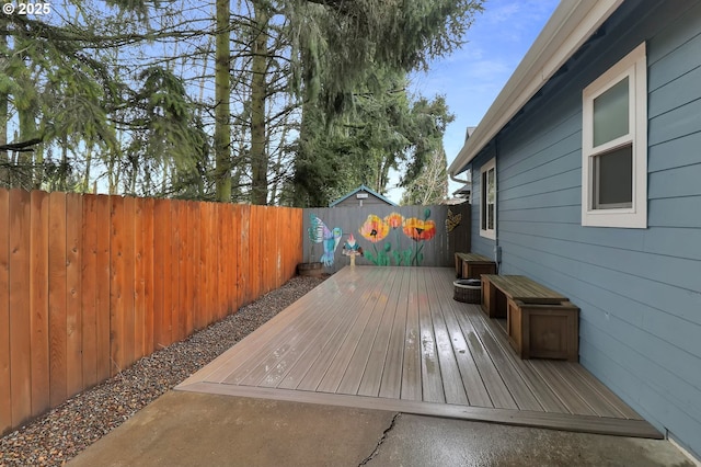 wooden deck featuring a fenced backyard