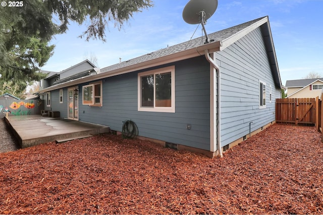 back of property featuring a gate, a patio, and fence