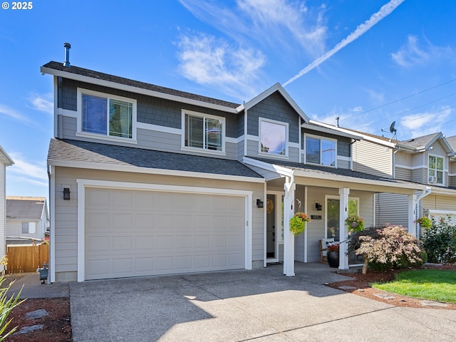 view of front of house with a garage, covered porch, a shingled roof, and concrete driveway