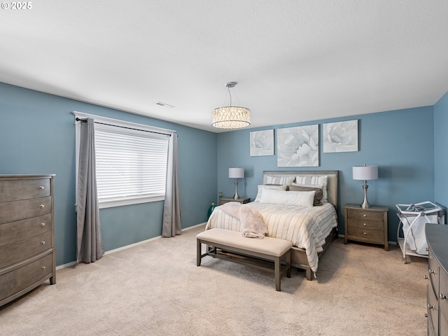 bedroom with baseboards and light colored carpet