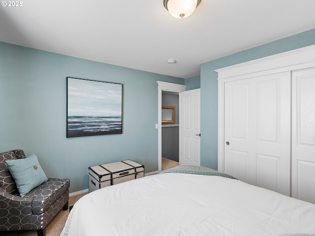 bedroom featuring carpet, a closet, and baseboards