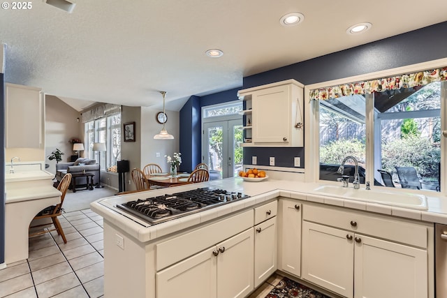 8650 SW Turquoise Loop, Beaverton, OR 97007 - kitchen featuring a sink, stainless steel gas cooktop, french doors, white cabinetry, and open floor plan