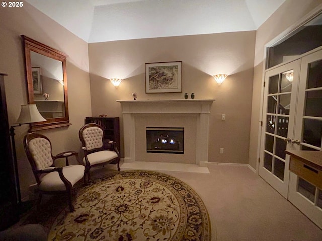 8650 SW Turquoise Loop, Beaverton, OR 97007 - living area with carpet, a fireplace with flush hearth, french doors, vaulted ceiling, and baseboards