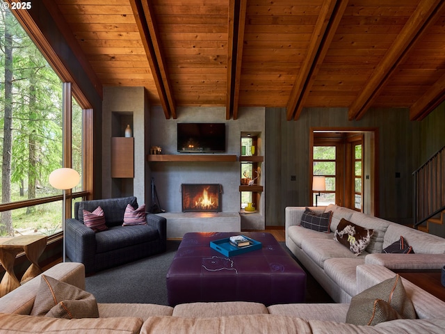 71183 Bracken Ln Unit Gh76, Black Butte Ranch, OR 97759 - living room featuring a wooden ceiling with exposed beams, a large fireplace, plenty of natural light, and stairway