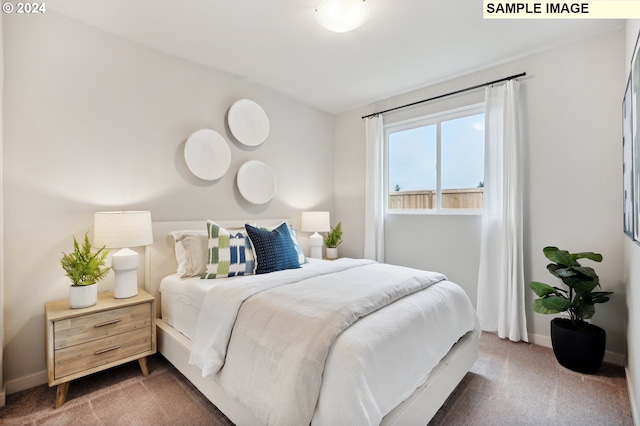 bedroom with baseboards and carpet flooring