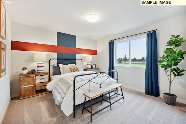 bedroom with carpet, visible vents, and baseboards