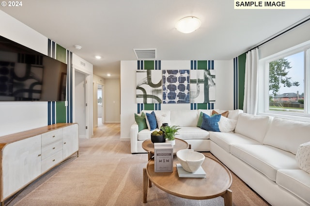 living area with light colored carpet, visible vents, baseboards, and recessed lighting