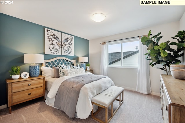 carpeted bedroom featuring baseboards