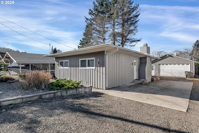 view of front of home featuring a garage and an outdoor structure