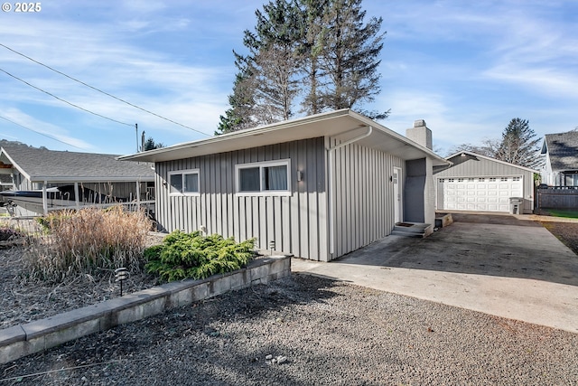 view of front of property with a garage and an outdoor structure