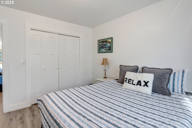 bedroom featuring a closet and light wood-type flooring