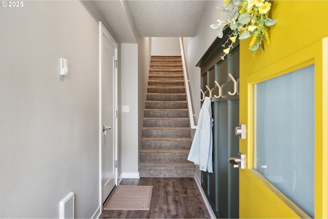 staircase with wood finished floors and baseboards