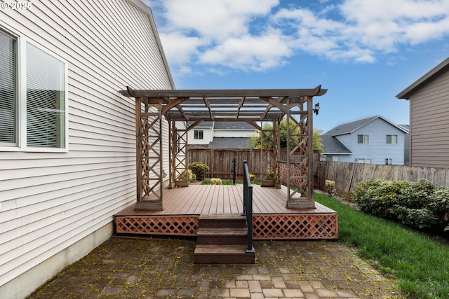 wooden deck with a fenced backyard, a pergola, and a patio area