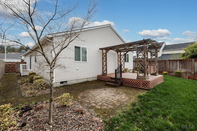back of house with a wooden deck, a pergola, a patio, a fenced backyard, and a yard