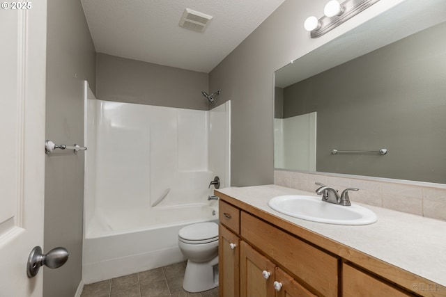 full bathroom with visible vents, vanity, bathing tub / shower combination, toilet, and tile patterned floors