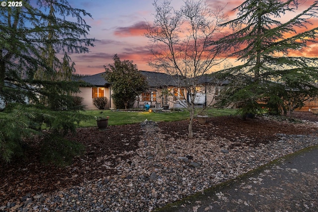 ranch-style home featuring a lawn