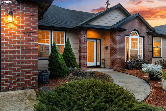 view of exterior entry at dusk