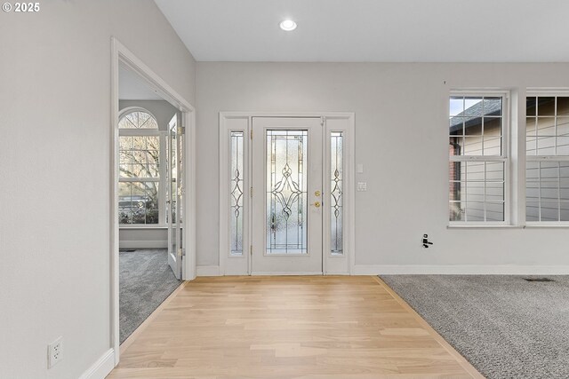 foyer featuring a wealth of natural light and light hardwood / wood-style flooring