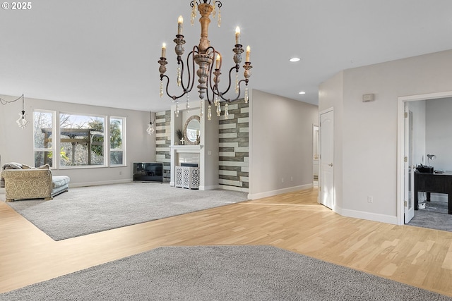 living room with an inviting chandelier and light wood-type flooring