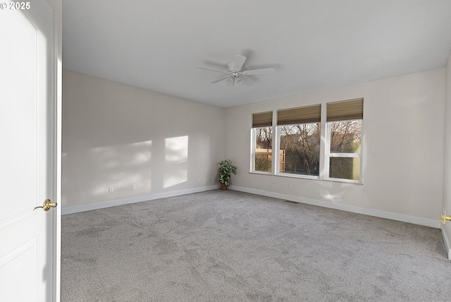 carpeted empty room featuring ceiling fan