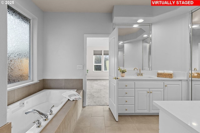 bathroom featuring vanity, tile patterned floors, and tiled bath