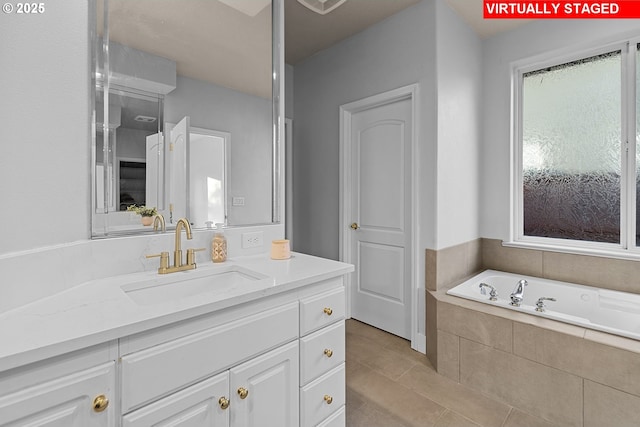 bathroom featuring vanity, tiled tub, and tile patterned floors