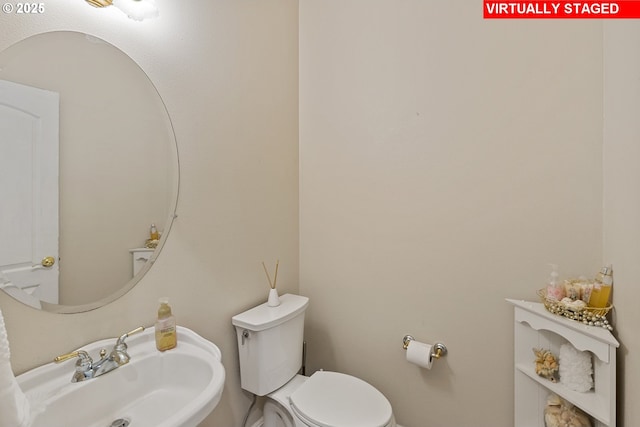 bathroom featuring sink and toilet