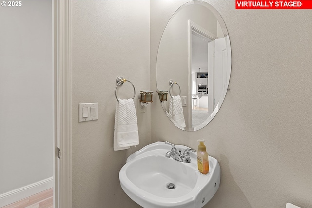 bathroom featuring wood-type flooring and sink