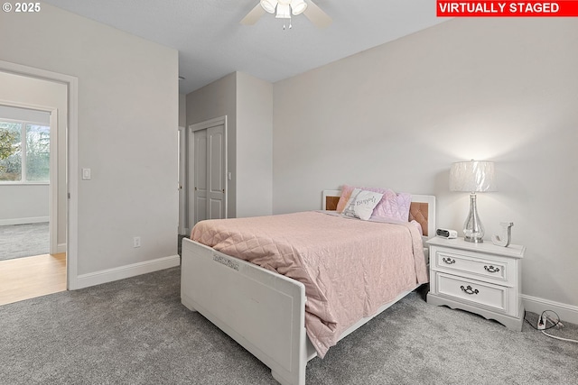 carpeted bedroom featuring ceiling fan and a closet