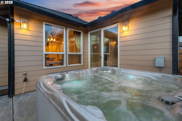 patio terrace at dusk with a hot tub