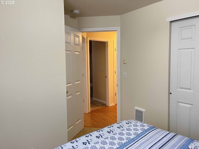 bedroom featuring hardwood / wood-style flooring and a closet