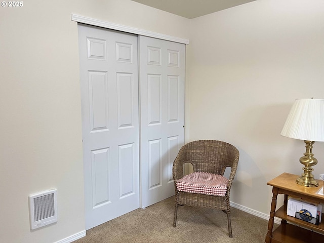 sitting room featuring carpet flooring