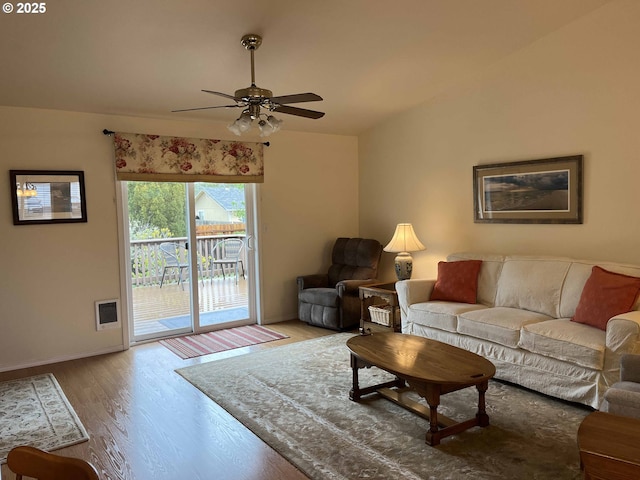 living room with ceiling fan and light hardwood / wood-style flooring