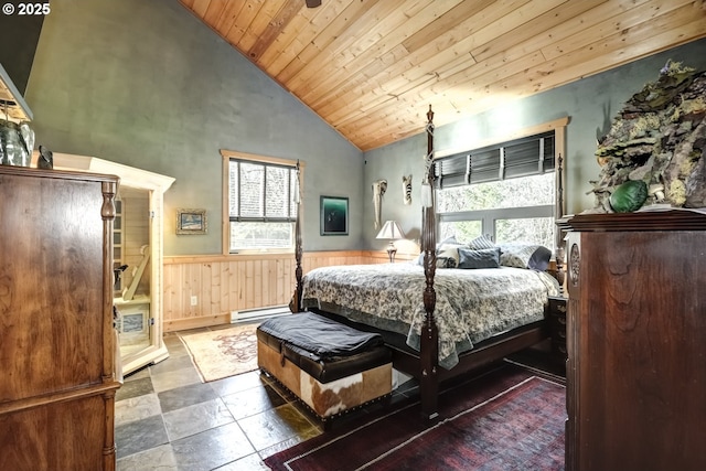 bedroom featuring high vaulted ceiling, baseboard heating, wainscoting, and wood ceiling