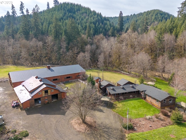 birds eye view of property with a forest view