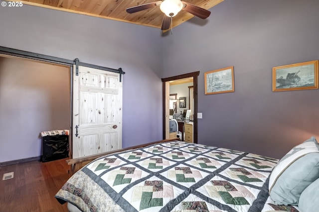 bedroom with wooden ceiling, wood finished floors, a barn door, ceiling fan, and baseboards