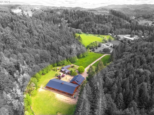 view from above of property with a heavily wooded area and mountains